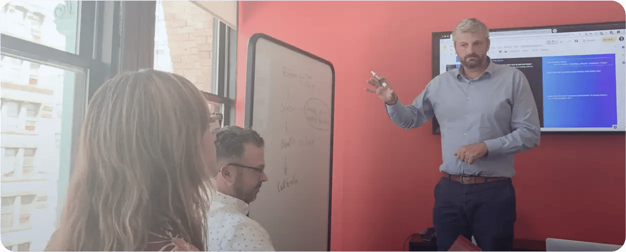 Easy movie employee in a meeting pointing to a whiteboard